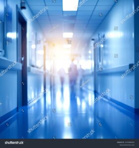 stock-photo-blurred-hallway-in-a-hospital-2453494243
